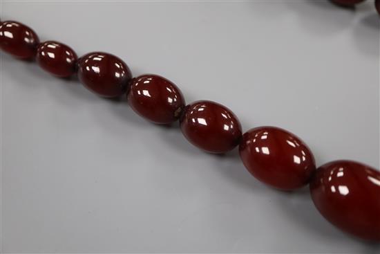 A single strand graduated simulated cherry amber bead necklace, 72cm, gross 61 grams.